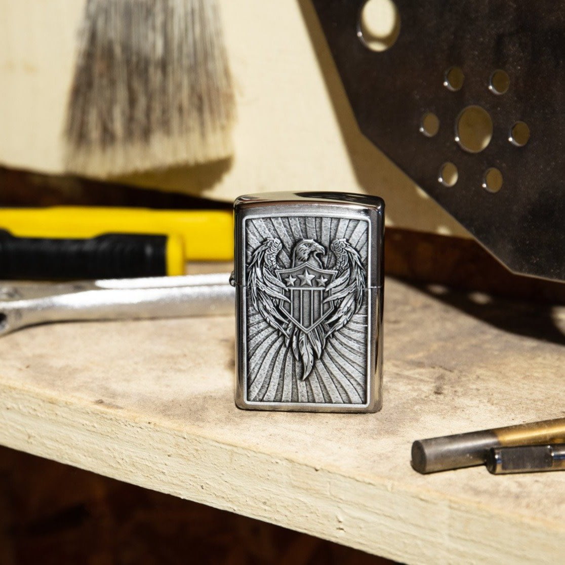 Lifestyle image of Eagle Shield Emblem Design Street Chrome?äó Windproof Lighter standing on a workbench with tools.