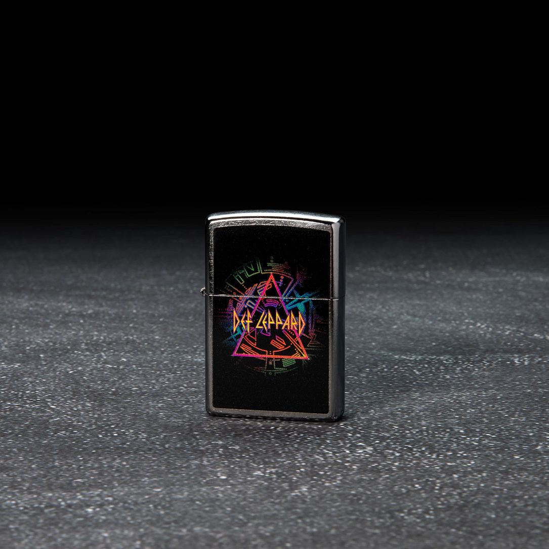Lifestyle image of Def Leppard Design Street Chrome?äó Windproof Lighter standing in a dark scene.
