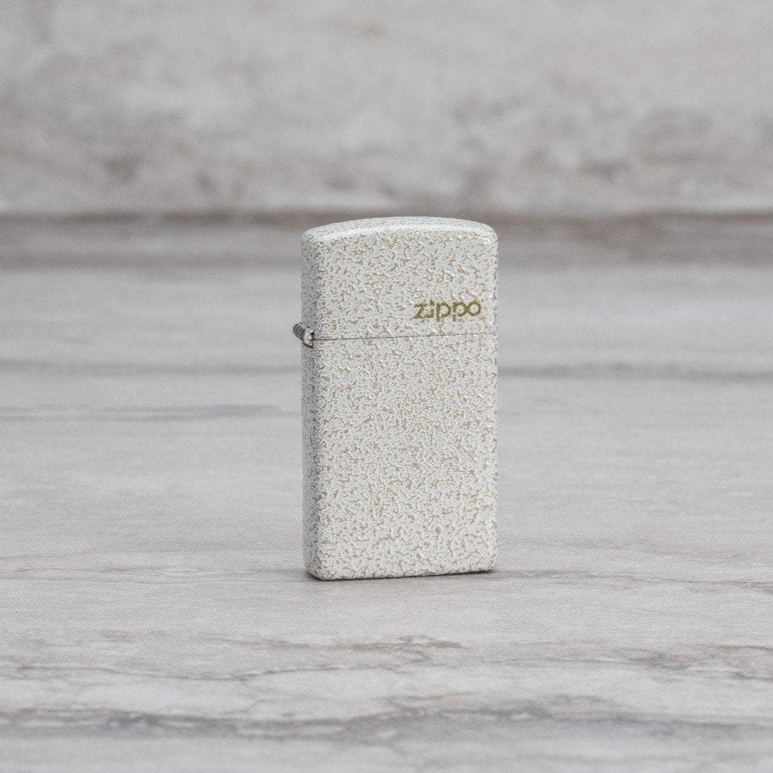 Lifestyle image of Slim?« Mercury Glass Zippo Logo Windproof Lighter standing on a marble surface