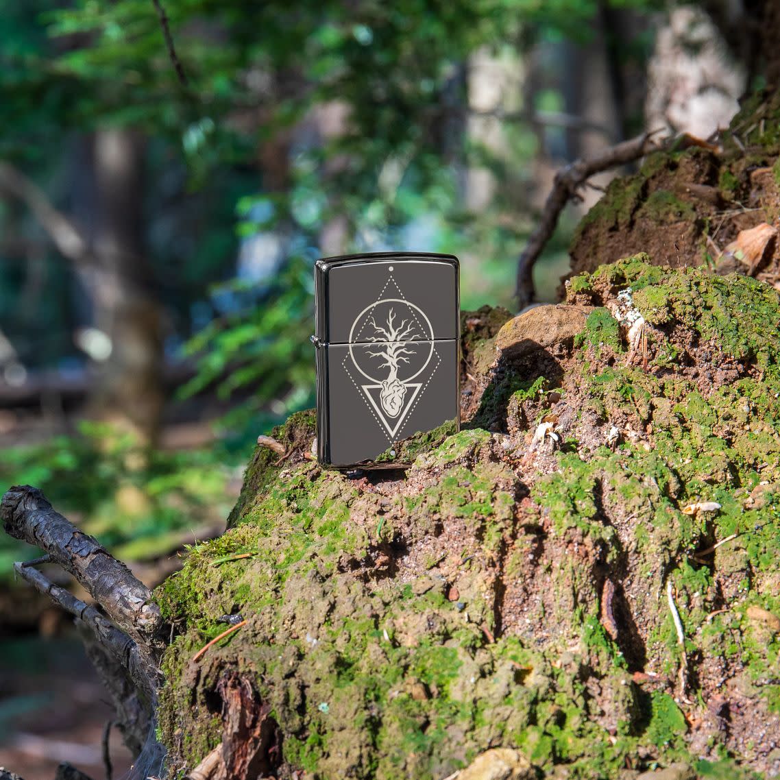 Lifestyle image of Heart Of Tree Design Black Ice?« Windproof Lighter standing on a trees roots in the woods.