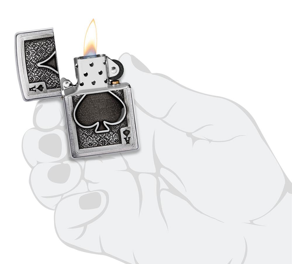 Ace Of Spades Emblem Brushed Chrome Windproof Lighter lit in hand.